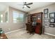 Office area with a wooden hutch desk, ceiling fan, and view through window at 6711 E Camelback Rd # 43, Scottsdale, AZ 85251