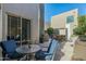 Inviting patio features a glass-top table with blue cushioned chairs perfect for enjoying the outdoors at 6711 E Camelback Rd # 43, Scottsdale, AZ 85251