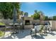 Inviting outdoor patio with a fireplace, seating, and serene desert landscaping for relaxing and entertaining at 6711 E Camelback Rd # 43, Scottsdale, AZ 85251