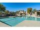 Beautiful community swimming pool with lounge chairs, umbrellas and desert landscaping at 6711 E Camelback Rd # 43, Scottsdale, AZ 85251