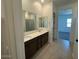 Bathroom featuring double vanity sinks, a large mirror, and a separate shower room at 7050 E Brushy Bill Rd, San Tan Valley, AZ 85143