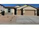 Charming single-story home features a stone facade, two-car garage and neutral-colored stucco at 7050 E Brushy Bill Rd, San Tan Valley, AZ 85143