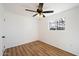 Cozy bedroom featuring neutral walls, wood-look floors, and a ceiling fan for added comfort at 737 W Jones Ave, Phoenix, AZ 85041