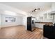 Modern kitchen with stainless steel appliances, white cabinets, and laminate floors for a fresh and clean look at 737 W Jones Ave, Phoenix, AZ 85041