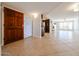 Bright entryway featuring a wooden front door leading to a spacious living area with neutral tile flooring at 7800 E Lincoln E Dr # 1102, Scottsdale, AZ 85250