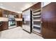 Well-lit kitchen featuring stainless steel appliances and custom dark wood cabinets with pull-out shelves at 7800 E Lincoln E Dr # 1102, Scottsdale, AZ 85250