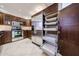 Kitchen featuring stainless steel appliances, built-in pantry shelves, and sleek wood cabinetry at 7800 E Lincoln E Dr # 1102, Scottsdale, AZ 85250