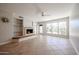 Inviting living room featuring a cozy fireplace, built-in shelves, and large windows for natural light at 7800 E Lincoln E Dr # 1102, Scottsdale, AZ 85250