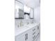 Bright bathroom featuring double sink vanity, black hardware, and decorative mirrors at 837 E Divot Dr, Tempe, AZ 85283