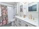 Bright bathroom featuring a double sink vanity, modern fixtures, and subway tiled shower over tub at 837 E Divot Dr, Tempe, AZ 85283