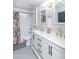 Bright bathroom featuring a double sink vanity, modern fixtures, and subway tiled shower over tub at 837 E Divot Dr, Tempe, AZ 85283