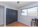 Bedroom with light wood floors, spacious closet, natural light from large window, and neutral walls at 837 E Divot Dr, Tempe, AZ 85283