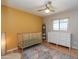 Well-lit Bedroom with hardwood floors and a mustard accent wall at 837 E Divot Dr, Tempe, AZ 85283