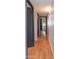 Hallway with dark trim, hardwood floors, and neutral colored walls at 837 E Divot Dr, Tempe, AZ 85283