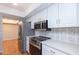 Bright kitchen featuring white cabinets, stainless steel appliances, and stylish backsplash at 837 E Divot Dr, Tempe, AZ 85283