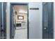 Stylish laundry room featuring patterned tile, a modern washer/dryer set, and ample cabinet space at 837 E Divot Dr, Tempe, AZ 85283