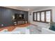 Inviting living room with hardwood floors, modern furniture, grey accent wall, and large windows with decorative grilles at 837 E Divot Dr, Tempe, AZ 85283