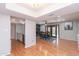 Open concept living room with wood floors, recessed lights and seamless access to the dining area at 837 E Divot Dr, Tempe, AZ 85283