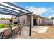 Inviting backyard featuring a pergola with outdoor seating, a play structure, and low-maintenance landscaping at 8850 W Laurel Ln, Peoria, AZ 85345