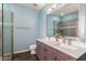 Modern bathroom with dual sinks, a shower, and stylish fixtures at 8850 W Laurel Ln, Peoria, AZ 85345