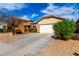 A charming one-story home with a two-car garage and a well-manicured front yard at 8850 W Laurel Ln, Peoria, AZ 85345