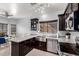 Charming kitchen featuring granite counters, stainless steel appliances, and a farmhouse sink at 8850 W Laurel Ln, Peoria, AZ 85345