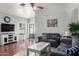 Cozy living room featuring wood floors, a ceiling fan, and lots of natural light at 8850 W Laurel Ln, Peoria, AZ 85345