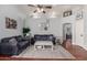 Inviting living room featuring hardwood floors, a ceiling fan, and a large decorative rug at 8850 W Laurel Ln, Peoria, AZ 85345