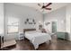 Bright main bedroom with high ceilings, ceiling fan, and ensuite bathroom at 8850 W Laurel Ln, Peoria, AZ 85345