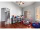 playroom featuring wood floors, neutral walls, and an arched doorway at 8850 W Laurel Ln, Peoria, AZ 85345