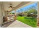 Covered patio overlooking a lush green lawn with desert landscaping at 891 W Palo Brea Dr, Litchfield Park, AZ 85340