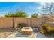 Outdoor seating area with a stone fire pit and desert landscaping at 891 W Palo Brea Dr, Litchfield Park, AZ 85340