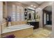 Bright bathroom features vessel sink, standalone tub, a large walk-in shower, and glass block windows at 891 W Palo Brea Dr, Litchfield Park, AZ 85340