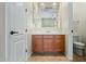 Bathroom featuring wood vanity, framed mirror, and a toilet at 891 W Palo Brea Dr, Litchfield Park, AZ 85340