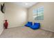 Bright bedroom with a window, fan, TV, and two casual blue beanbag chairs at 891 W Palo Brea Dr, Litchfield Park, AZ 85340