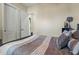 Bedroom featuring neutral colored walls, carpeted floors, white closet doors, and comfortable bedding at 891 W Palo Brea Dr, Litchfield Park, AZ 85340