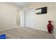 Carpeted bedroom with a ceiling fan, TV, closet, and accent vase at 891 W Palo Brea Dr, Litchfield Park, AZ 85340