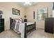 Cozy bedroom featuring neutral colored walls, carpeted floors, ceiling fan, and a comfortable bed at 891 W Palo Brea Dr, Litchfield Park, AZ 85340