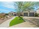 Beautiful home with lush artificial turf and a long, winding driveway leading to a spacious three-car garage at 891 W Palo Brea Dr, Litchfield Park, AZ 85340