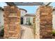 Inviting walkway through stone columns leads to the front door at 891 W Palo Brea Dr, Litchfield Park, AZ 85340