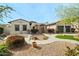 Charming home featuring desert landscaping, a stone pathway, and a spacious three-car garage at 891 W Palo Brea Dr, Litchfield Park, AZ 85340