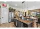 Open kitchen island featuring granite countertop, stone accents, stainless sink, and pendant lighting at 891 W Palo Brea Dr, Litchfield Park, AZ 85340