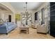 Bright, airy living room with stylish decor, tile flooring, neutral walls, and natural light at 891 W Palo Brea Dr, Litchfield Park, AZ 85340