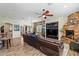 Bright living room with a stone fireplace, plush seating, and an open flow to the dining area at 891 W Palo Brea Dr, Litchfield Park, AZ 85340