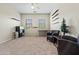 Neutral living room featuring light walls, carpet, two chairs, shelves, and natural lighting at 891 W Palo Brea Dr, Litchfield Park, AZ 85340