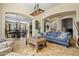 Inviting living room with stone tile flooring, stylish furnishings, and an open floor plan layout at 891 W Palo Brea Dr, Litchfield Park, AZ 85340