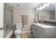 A clean bathroom featuring a toilet, vanity, mirror, and walk-in shower at 932 W Julie Dr, Tempe, AZ 85283