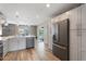 Modern kitchen featuring white cabinets, stainless steel appliances, and a view to the patio at 932 W Julie Dr, Tempe, AZ 85283