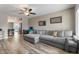 Inviting living room featuring hardwood floors, a comfortable sofa, and a ceiling fan at 932 W Julie Dr, Tempe, AZ 85283