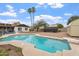 Backyard pool area with desert landscaping, pool house, and privacy fence at 932 W Julie Dr, Tempe, AZ 85283